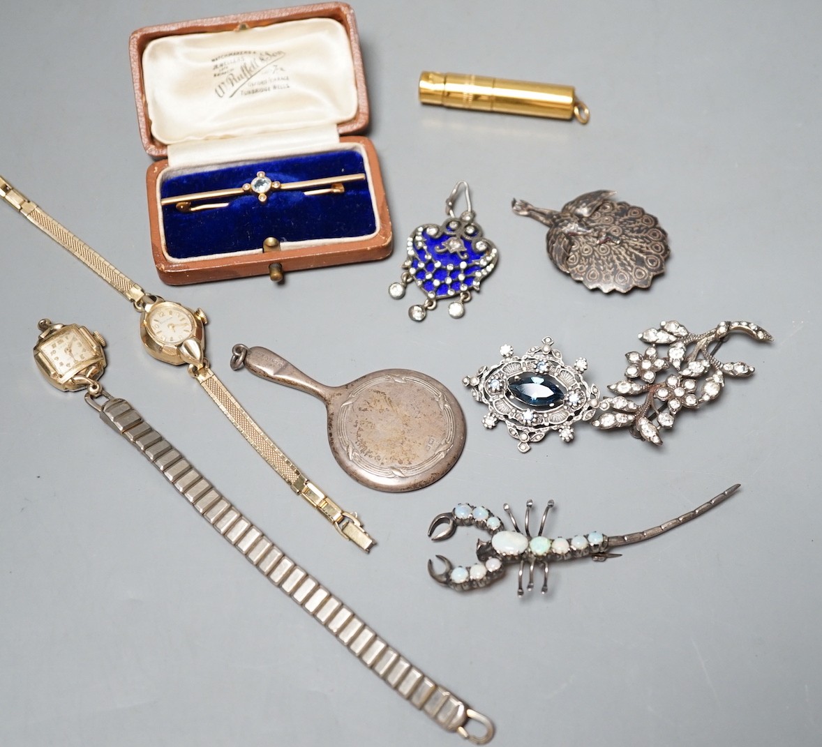 A cased Edwardian yellow metal, aquamarine and seed pearl set bar brooch, 55mm, sundry jewellery including costume, opal set scorpion brooch and enamel and paste set drop pendant and a wrist watch.